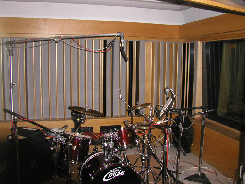 SF-12 stereo ribbon mic angled at 45 degrees over a drum kit in a low-ceilinged isolation booth